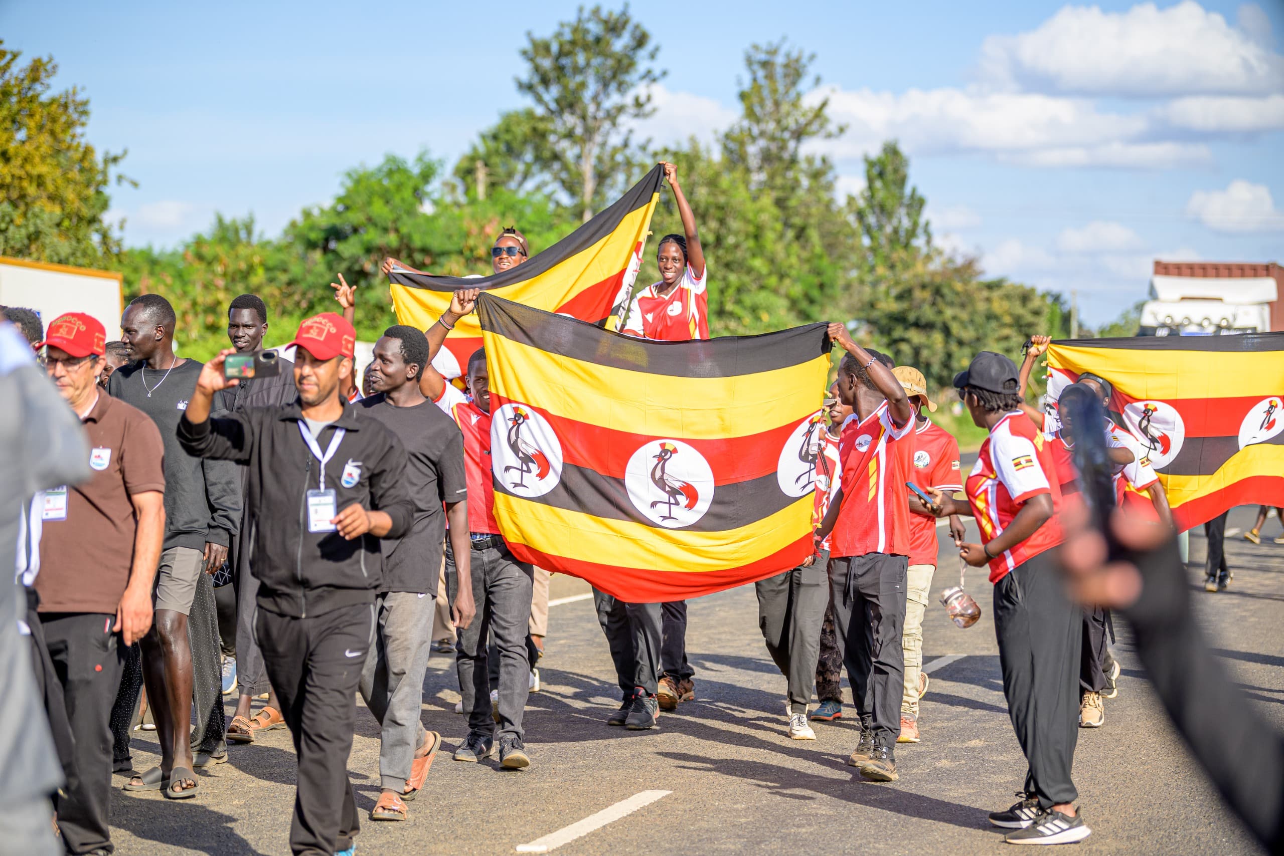 Team Uganda rafters holding the national flag at a competition